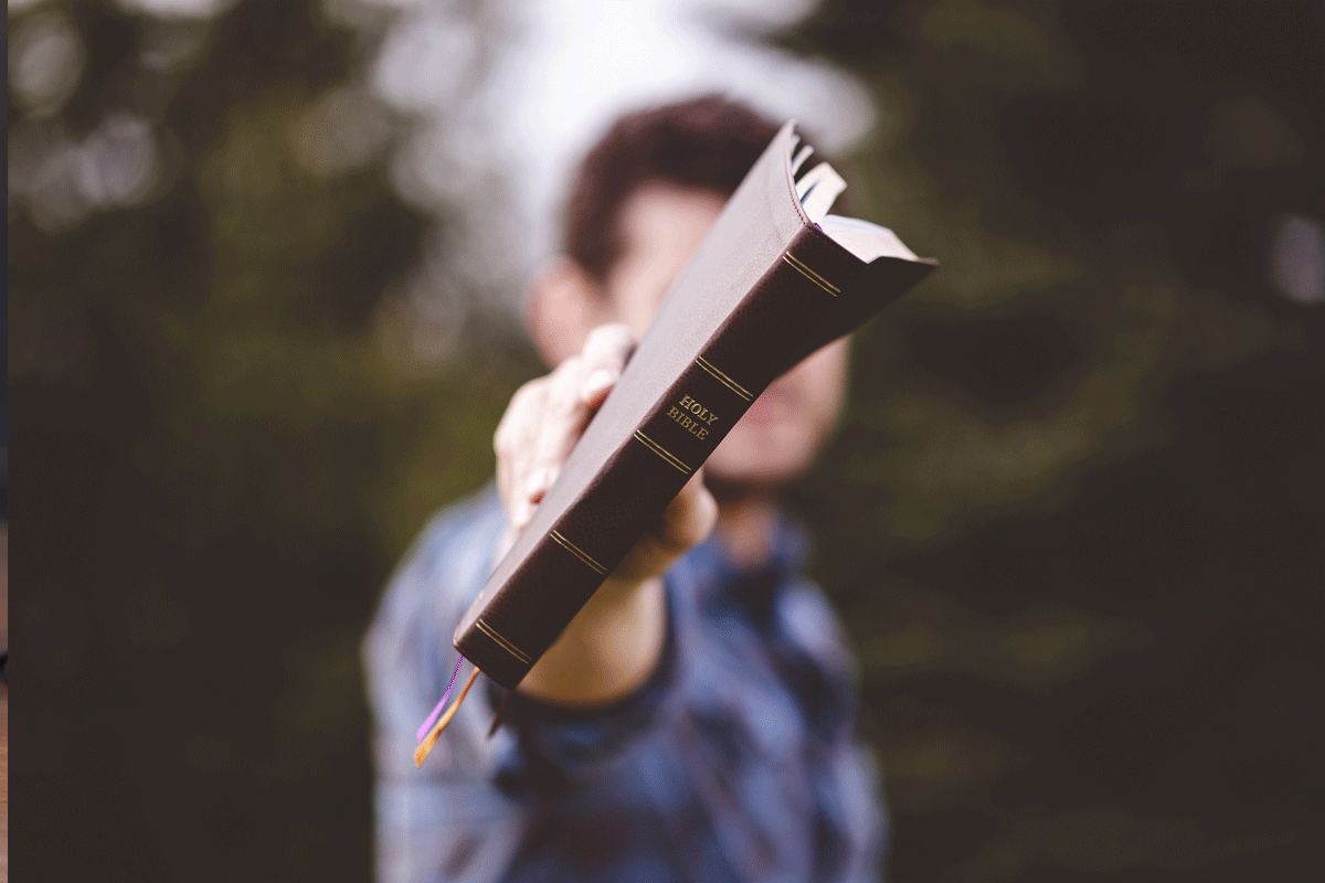Man holding Bible for the Best Bible for Beginners